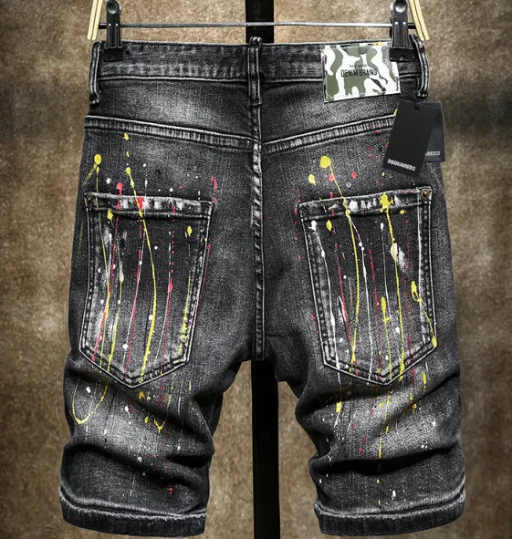 Yellow-painted distressed denim shorts
